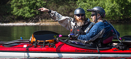 Krista and Just Kayak More president, Jason Montelongo, confer on the right line to take during a training session. Photo by Tom Gomes.